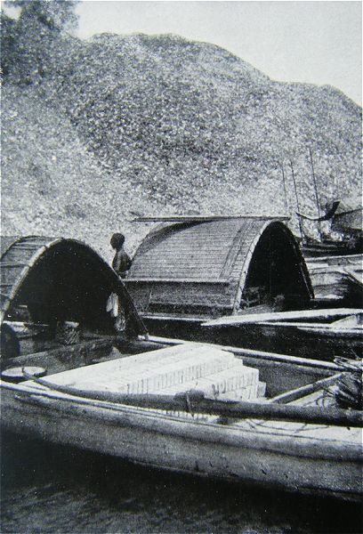 Boats loaded with soft, white clay bricks for the porcelain factories